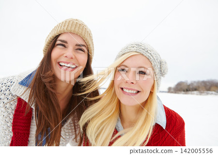 Friends, girls and happy together in snow to explore or have fun on vacation in Canada in Christmas season. Woman, outdoor and travel on winter holiday getaway for adventure or bonding with love. Friends, girls and happy together in snow to explore or have fun on vacation in Canada in Christmas season. Woman, outdoor and travel on winter holiday getaway for adventure or bonding with love. 142005556