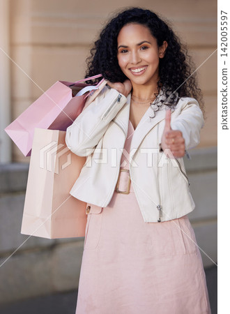 Woman, thumbs up and shopping bag in city with portrait, smile and excited for deal, sale or discount. Girl, happy and sign for yes, like and review of customer experience on metro sidewalk in Mexico Woman, thumbs up and shopping bag in city with portrait, smile and excited for deal, sale or discount. Girl, happy and sign for yes, like and review of customer experience on metro sidewalk in Mexico 142005597