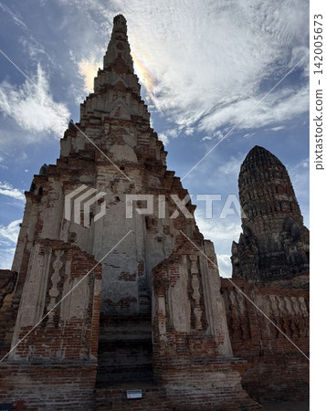 A landscape with stupas and Buddha statues, and a rainbow cloud, as seen in Ayutthaya. A landscape with stupas and Buddha statues, and a rainbow cloud, as seen in Ayutthaya. 142005673