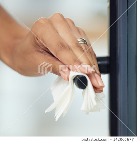 Woman, hand and cleaning of door handle with tissue for bacteria, hygiene or disinfection in home. Person, cleaner and housework with sanitation for dust, housekeeping or daily routine for protection 142005677
