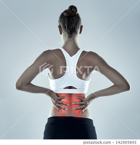 Exercise, injury and back pain, woman and red glow for spine x ray or bone isolated on grey background. Fitness, athlete and anatomy overlay with inflammation, muscle or tendon tension in studio Exercise, injury and back pain, woman and red glow for spine x ray or bone isolated on grey background. Fitness, athlete and anatomy overlay with inflammation, muscle or tendon tension in studio 142005691