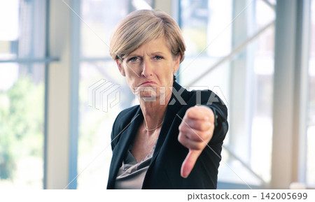 Portrait, thumbs down and mature business woman with sad face, opinion or no fail sign. Negative, hand gesture and dislike for vote, feedback or review of CEO with wrong emoji for problem in office Portrait, thumbs down and mature business woman with sad face, opinion or no fail sign. Negative, hand gesture and dislike for vote, feedback or review of CEO with wrong emoji for problem in office 142005699