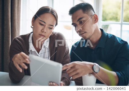 Couple, home and table with tablet for home finance or loan application. People, relationship and internet for information or website on news update with digital nomad or technology for planning. Couple, home and table with tablet for home finance or loan application. People, relationship and internet for information or website on news update with digital nomad or technology for planning. 142006041