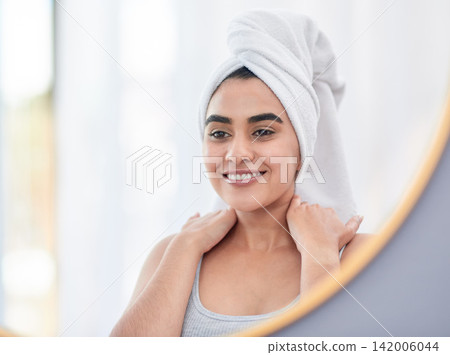 Happy, woman and skincare with head towel and natural face with shine in mirror reflection. Female model, dermatology and facial treatment with smile for routine, wellness and spa care in bathroom Happy, woman and skincare with head towel and natural face with shine in mirror reflection. Female model, dermatology and facial treatment with smile for routine, wellness and spa care in bathroom 142006044