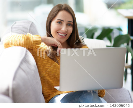 Smile, laptop and portrait of woman on sofa watching funny movie, film or show in living room together. Laughing, happy and female person streaming comedy video online with computer in lounge at home Smile, laptop and portrait of woman on sofa watching funny movie, film or show in living room together. Laughing, happy and female person streaming comedy video online with computer in lounge at home 142006045