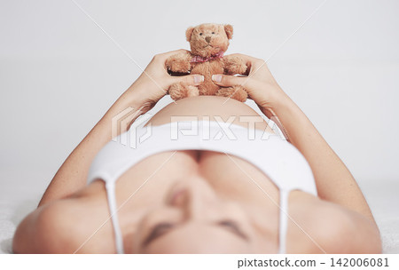 Pregnant, woman or teddy bear in maternity, bed or hope of health, wellness or idea of peace in home. Pregnancy, mama or plush toy to imagine, future or motherhood as vision of prenatal comfort Pregnant, woman or teddy bear in maternity, bed or hope of health, wellness or idea of peace in home. Pregnancy, mama or plush toy to imagine, future or motherhood as vision of prenatal comfort 142006081