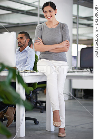Business woman, portrait and colleague working on project for management, start up and corporate. Person, coworker or employee in company sitting on desk smiling, confident and proud in office 142006097