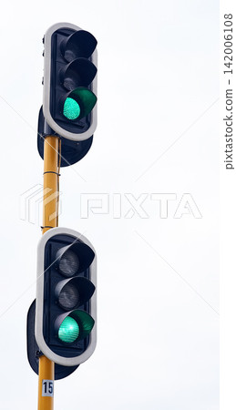 Traffic light, green and city intersection on street for go instruction, transportation or downtown. Road safety, commute and urban rules for traveling directions or infrastructure, driving or public Traffic light, green and city intersection on street for go instruction, transportation or downtown. Road safety, commute and urban rules for traveling directions or infrastructure, driving or public 142006108