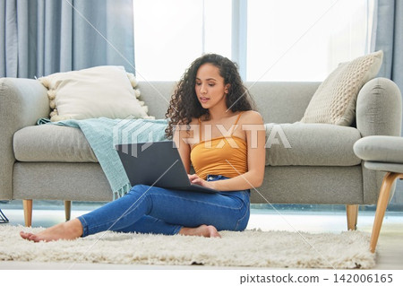 Laptop, floor and woman in home online for remote work, online shopping and browse internet. Weekend, apartment and person on computer for social networking, website and research in living room Laptop, floor and woman in home online for remote work, online shopping and browse internet. Weekend, apartment and person on computer for social networking, website and research in living room 142006165