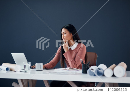 Architecture, research and Asian woman with laptop, blueprint and insight for creative ideas in office. Thinking, internet and architect with computer, paperwork and building development inspiration. Architecture, research and Asian woman with laptop, blueprint and insight for creative ideas in office. Thinking, internet and architect with computer, paperwork and building development inspiration. 142006213