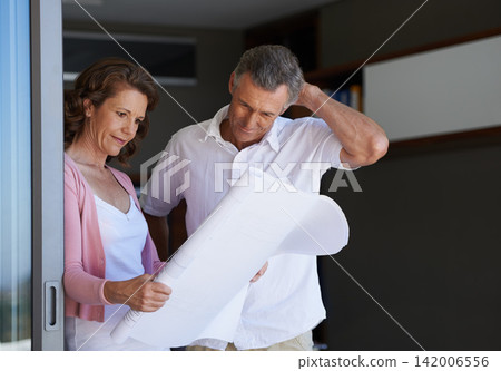 Mature couple, planning and interior design with blueprint or documents for maintenance or renovation at house. Creative man or woman with paperwork or floor layout for home improvement or startup 142006556