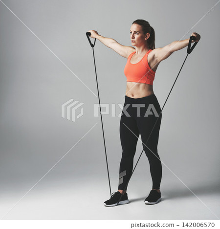 Woman, fitness and resistance band in studio with stretch for healthy athlete with training for wellness. Body care, gym and confidence with commitment on white background with workout for exercise Woman, fitness and resistance band in studio with stretch for healthy athlete with training for wellness. Body care, gym and confidence with commitment on white background with workout for exercise 142006570