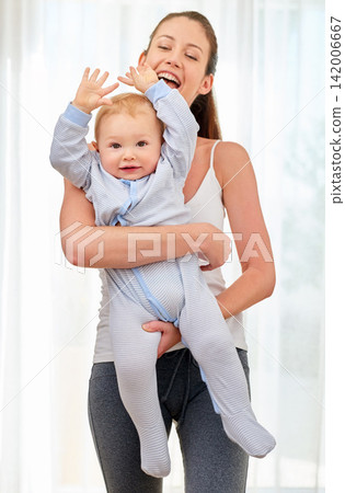 Mother, baby and hands with smile in portrait for bond, learning and development with time management. Mom, child and together in house for motor skills or wellness, happiness in home or living room Mother, baby and hands with smile in portrait for bond, learning and development with time management. Mom, child and together in house for motor skills or wellness, happiness in home or living room 142006667