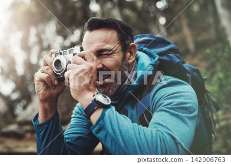 Nature, camera and man in forest for photography, travel and hiking, journey or memory. Jungle, backpack and mature wildlife photographer with digital lens for adventure, explore or outdoor discovery 142006763