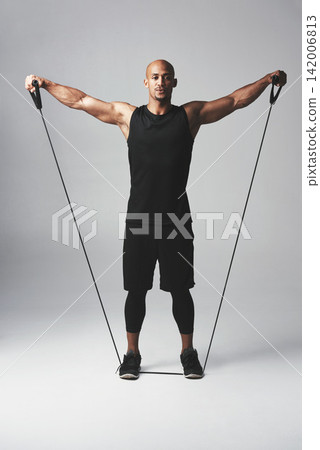 Man, fitness and resistance band in studio with stretch for healthy athlete with wellness for training. Gym, body care and confidence with commitment on white background with exercise for workout Man, fitness and resistance band in studio with stretch for healthy athlete with wellness for training. Gym, body care and confidence with commitment on white background with exercise for workout 142006813