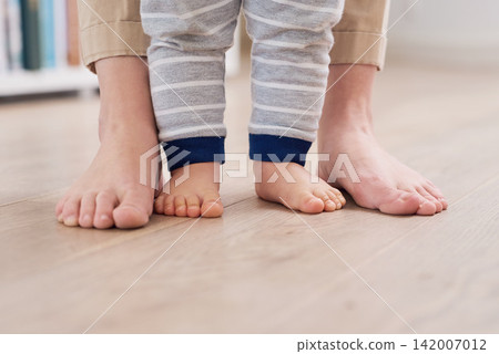 Parent and baby feet, learning for growth, support and first steps to healthy development in closeup. Person, teaching and child to walk, balance and fine motor skills at home with love and hope Parent and baby feet, learning for growth, support and first steps to healthy development in closeup. Person, teaching and child to walk, balance and fine motor skills at home with love and hope 142007012