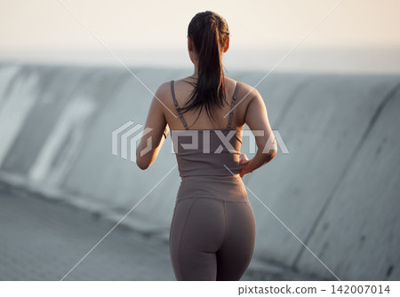 Fitness, running and woman in outdoor exercise in body health, energy or wellness from back. Workout, commitment and girl runner with dedication to morning marathon training, performance or cardio Fitness, running and woman in outdoor exercise in body health, energy or wellness from back. Workout, commitment and girl runner with dedication to morning marathon training, performance or cardio 142007014