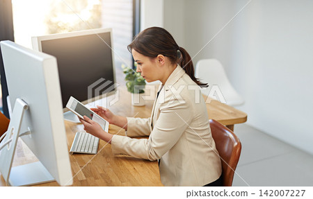 Business woman, app and trader tablet with cryptocurrency investment career at desk reading. Office, online data and digital investing work of an employee with stock research at a corporate company Business woman, app and trader tablet with cryptocurrency investment career at desk reading. Office, online data and digital investing work of an employee with stock research at a corporate company 142007227