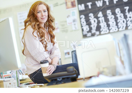 Happy, woman and coffee break to relax at desk in office, morning schedule and portrait. Creative, employee and receptionist with cup with tea or espresso to drink at work with calm moment at table Happy, woman and coffee break to relax at desk in office, morning schedule and portrait. Creative, employee and receptionist with cup with tea or espresso to drink at work with calm moment at table 142007229