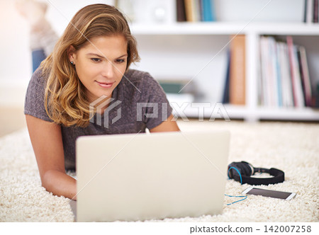 Relax, streaming or woman on laptop on carpet to chill with internet connection for film, video or movie online. Ground, break and girl on social media, blog and technology for subscription in home Relax, streaming or woman on laptop on carpet to chill with internet connection for film, video or movie online. Ground, break and girl on social media, blog and technology for subscription in home 142007258