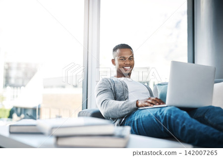 Man, portrait and remote work with laptop in home office on sofa with online research and writing code. Email, communication and happy web developer with website, software and networking with client Man, portrait and remote work with laptop in home office on sofa with online research and writing code. Email, communication and happy web developer with website, software and networking with client 142007265