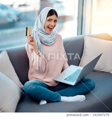 Credit card, portrait or Islamic girl on laptop in home for ecommerce sale on digital fintech website. Excited, payment or Muslim woman typing financial info for online shopping or internet banking Credit card, portrait or Islamic girl on laptop in home for ecommerce sale on digital fintech website. Excited, payment or Muslim woman typing financial info for online shopping or internet banking 142007270