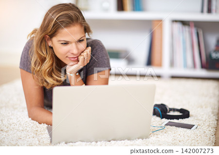 Relax, streaming or girl on laptop in house to chill with internet connection for film, video or movie online. Carpet, break and woman on social media, blog and technology for subscription in home 142007273