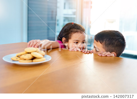 Home, girl and boy in kitchen, cookies and siblings together, brother and sister in morning or hungry. House, kid and cute child for bonding or biscuits on table, plate and food or dessert in weekend Home, girl and boy in kitchen, cookies and siblings together, brother and sister in morning or hungry. House, kid and cute child for bonding or biscuits on table, plate and food or dessert in weekend 142007317