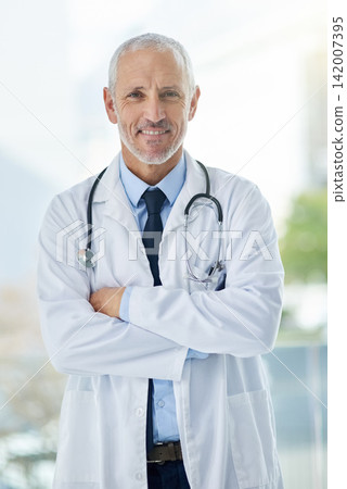 Doctor, confidence and portrait of mature man in a hospital at a cancer research clinic with arms crossed. Professional, medical employee and uniform with healthcare, wellness and health consultant Doctor, confidence and portrait of mature man in a hospital at a cancer research clinic with arms crossed. Professional, medical employee and uniform with healthcare, wellness and health consultant 142007395