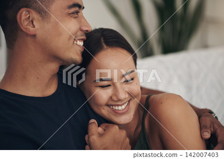 Couple, hug and laugh on sofa for bonding, humor and romance on home date and funny joke for comedy. People, holding hands and love in embrace for marriage, support and trust in connection or comfort 142007403