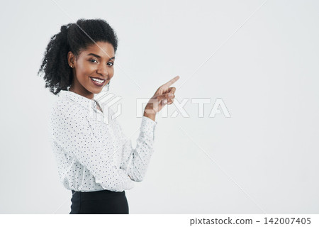Pointing, happy and portrait of business black woman in studio for promotion on white background. Advertising, professional and isolated person with hand gesture for announcement, news or information Pointing, happy and portrait of business black woman in studio for promotion on white background. Advertising, professional and isolated person with hand gesture for announcement, news or information 142007405