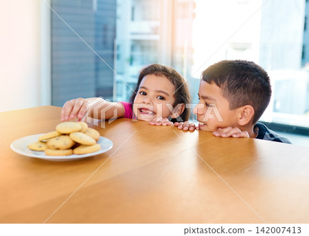 Steal, girl and boy in home, cookies and siblings together, brother and sister in morning or portrait. Kitchen, kid and cute child for bonding or biscuits on table, plate and dessert in weekend Steal, girl and boy in home, cookies and siblings together, brother and sister in morning or portrait. Kitchen, kid and cute child for bonding or biscuits on table, plate and dessert in weekend 142007413