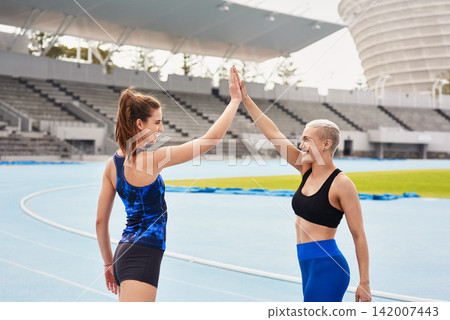 High five, sports and athletes on outdoor track, celebrate and winners of running competition. People, happy women and together for fitness at stadium, cardio and success at practice or training High five, sports and athletes on outdoor track, celebrate and winners of running competition. People, happy women and together for fitness at stadium, cardio and success at practice or training 142007443
