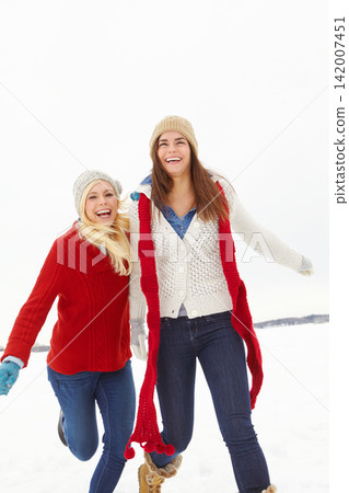 Winter, happy and lesbian couple outdoor in snow on romantic vacation, adventure or holiday. Love, smile and queer women in relationship for fun and bonding in cold weather on weekend trip in Iceland Winter, happy and lesbian couple outdoor in snow on romantic vacation, adventure or holiday. Love, smile and queer women in relationship for fun and bonding in cold weather on weekend trip in Iceland 142007451