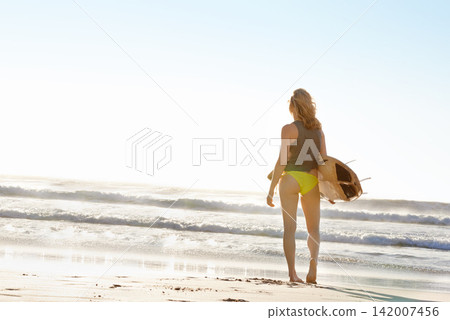 Woman, surfer and beach with surfboard, waves or blue sky for sport, hobby or outdoor freedom. Rear view of active female person in bikini on sand or ocean coast for swim or surfing with mockup space Woman, surfer and beach with surfboard, waves or blue sky for sport, hobby or outdoor freedom. Rear view of active female person in bikini on sand or ocean coast for swim or surfing with mockup space 142007456