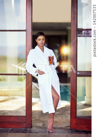 Door, woman and portrait at spa with tea on holiday, relax and break for luxury and mindfulness. Female person, resort and thinking with herbal drink on vacation, trip and travel for wellness 142007533