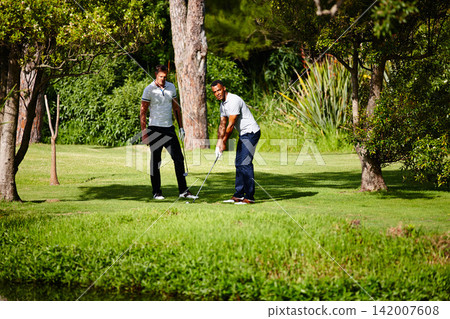 Summer, sport and friends on course for golf game or practice together at club in nature. People, training and playing on grass on luxury holiday or vacation in countryside with exercise or challenge Summer, sport and friends on course for golf game or practice together at club in nature. People, training and playing on grass on luxury holiday or vacation in countryside with exercise or challenge 142007608
