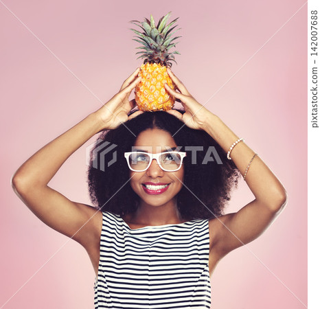 Smile, black woman and pineapple with fashion, studio and happy on pink background. Food, fruit and summer clothing aesthetic for female model, natural and ethical or sustainable clothing style Smile, black woman and pineapple with fashion, studio and happy on pink background. Food, fruit and summer clothing aesthetic for female model, natural and ethical or sustainable clothing style 142007688