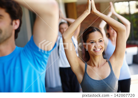 Woman, group and yoga class for workout, stretch and wellness for health and smile. People, fitness and zen for peace, eagle pose and balance with instructor for holistic energy with home pilates Woman, group and yoga class for workout, stretch and wellness for health and smile. People, fitness and zen for peace, eagle pose and balance with instructor for holistic energy with home pilates 142007720