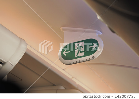 Emergency exit sign in an airplane cabin Emergency exit sign in an airplane cabin 142007753