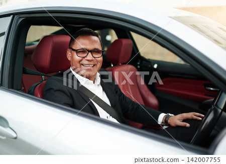 Portrait, mature man and happy with driving car as business person to test drive, experience and comfort. Vehicle, dealership and smile or satisfied with choice, features and safety as present Portrait, mature man and happy with driving car as business person to test drive, experience and comfort. Vehicle, dealership and smile or satisfied with choice, features and safety as present 142007755