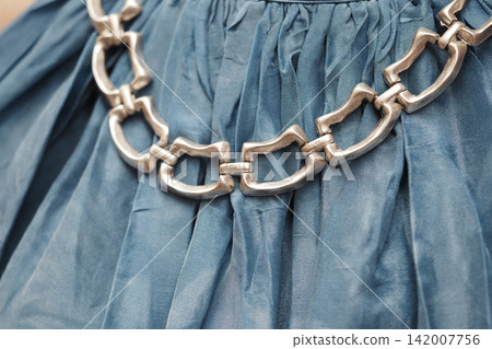 Fashion piece on clothing with a silver chain design 142007756