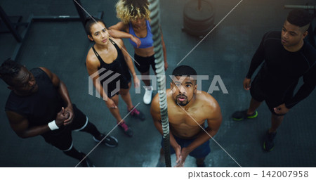 Man, group and rope for climbing in gym with challenge, start and training for strong muscle growth. Personal trainer, people or friends with exercise, workout and vision for coaching at fitness club Man, group and rope for climbing in gym with challenge, start and training for strong muscle growth. Personal trainer, people or friends with exercise, workout and vision for coaching at fitness club 142007958