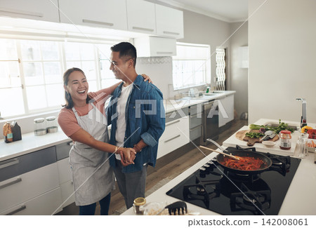 Dancing, cooking and couple in kitchen together with healthy food, relationship and bonding in home. Romance, happy man and woman in apartment with nutrition, care and meal prep with love for lunch Dancing, cooking and couple in kitchen together with healthy food, relationship and bonding in home. Romance, happy man and woman in apartment with nutrition, care and meal prep with love for lunch 142008061