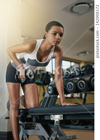 Woman, gym and weightlifting with dumbbells on bench for tricep workout for muscle, arms or training. Female person, bicep and challenge for weight loss exercise for health, wellness or bodybuilding Woman, gym and weightlifting with dumbbells on bench for tricep workout for muscle, arms or training. Female person, bicep and challenge for weight loss exercise for health, wellness or bodybuilding 142008172