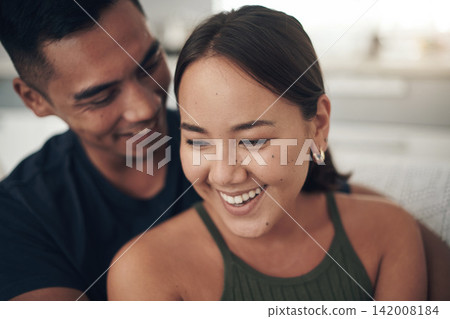 Couple, hug and laugh on couch for love, humor and romance on home date and funny joke for comedy. People, happy and bonding in embrace for marriage, support and trust in connection or comfort 142008184
