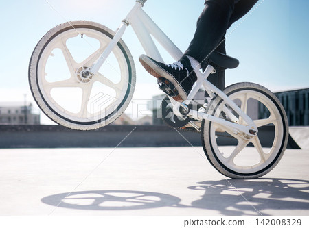 Trick, legs of boy and riding bicycle for hobby, daily activity and cycling for fun. Outside, male person and cyclist on a bike for exercise, leisure time or freedom for playing with biker Trick, legs of boy and riding bicycle for hobby, daily activity and cycling for fun. Outside, male person and cyclist on a bike for exercise, leisure time or freedom for playing with biker 142008329