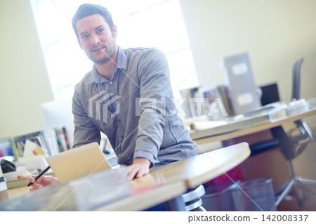 Man, tablet and graphic designer with desk for creative career, lens flare and startup business. Online work, morning and male teacher in staff room with school, technology and education for children Man, tablet and graphic designer with desk for creative career, lens flare and startup business. Online work, morning and male teacher in staff room with school, technology and education for children 142008337
