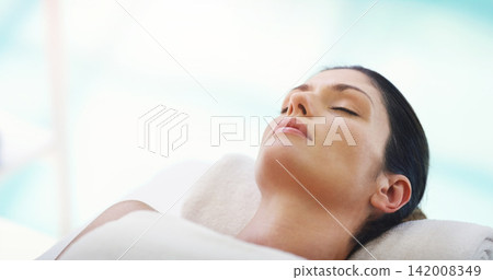 Salon, beauty and woman relax at spa for massage, facial treatment and luxury pamper. Aesthetic, skincare and person with eyes closed at resort for wellness, cosmetics service and dermatology therapy 142008349