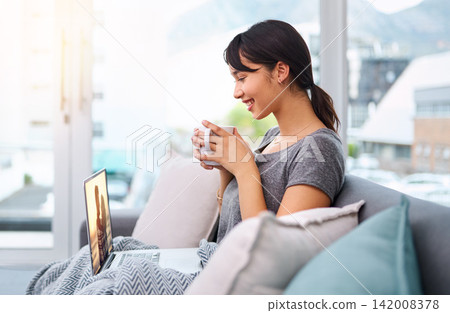 Laptop, coffee or girl streaming movie to relax in living room for online subscription, film or video. Drinking tea, smile or happy woman watching series on sofa for entertainment, comedy or break 142008378
